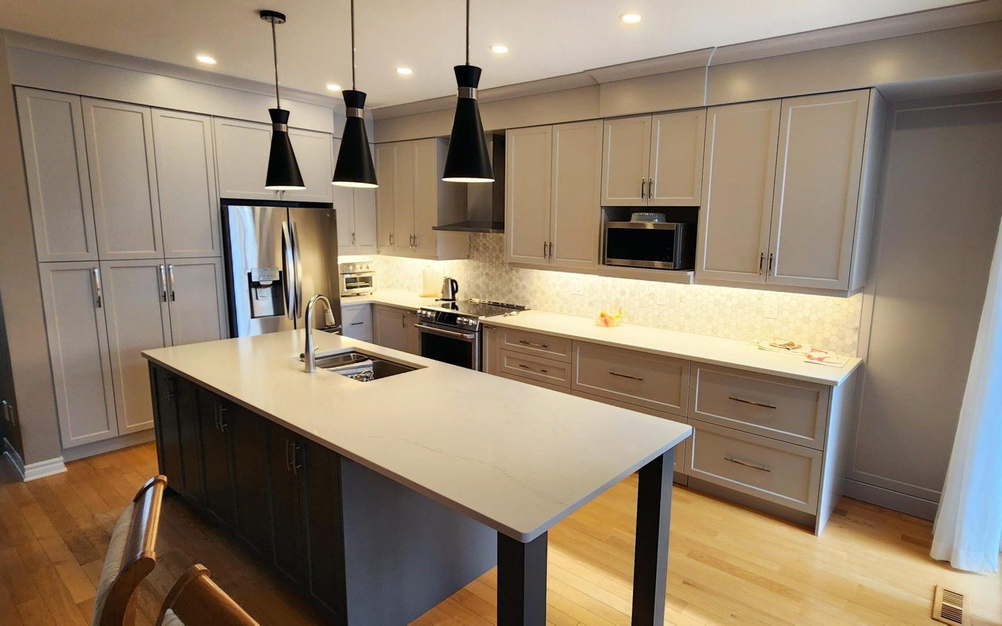 a kitchen with a center island with a sink