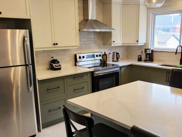 a kitchen with a refrigerator, stove, sink and table