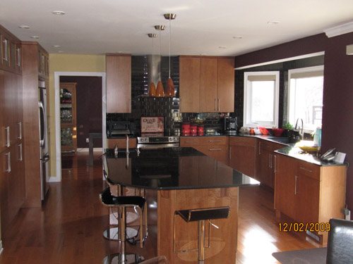 a large kitchen with a center island in the middle of the room