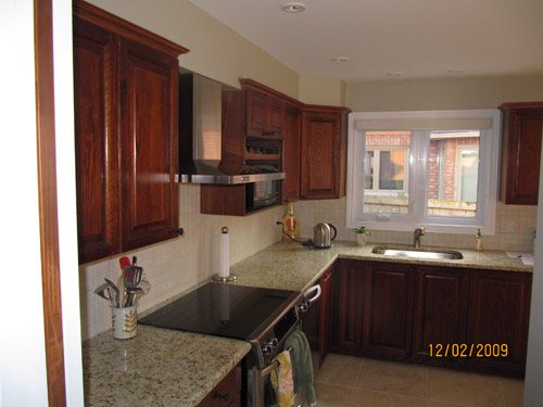 a kitchen with wooden cabinets and granite counter tops