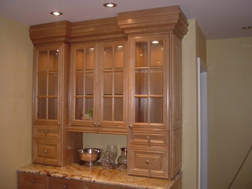 a kitchen with a marble counter top and wooden cabinets