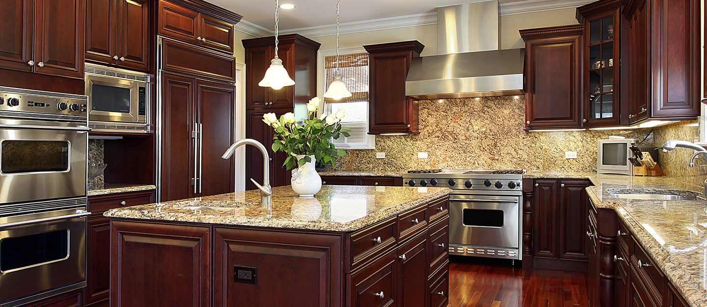 a kitchen with wooden cabinets and a marble counter top