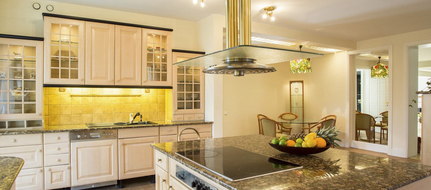 a kitchen with a bowl of fruit on the counter