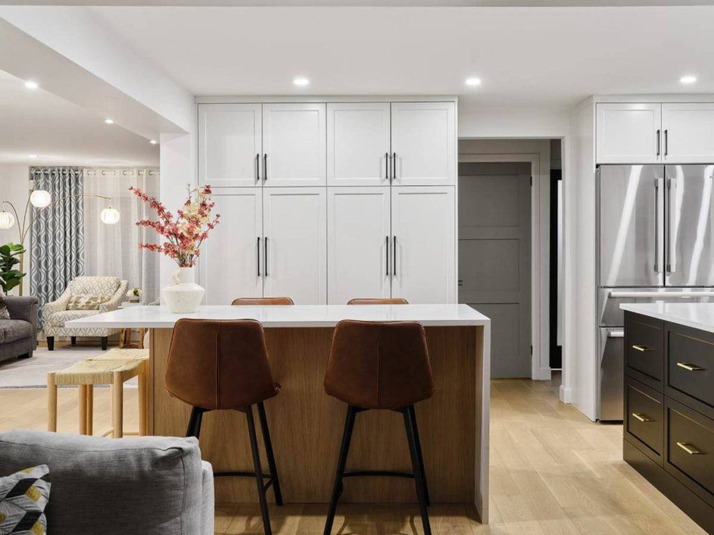 a kitchen with two stools and a center island